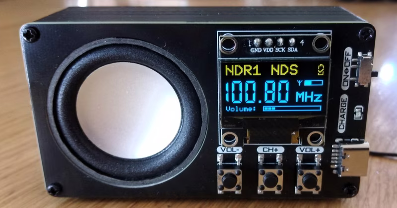 OLED display showing radio frequency and volume