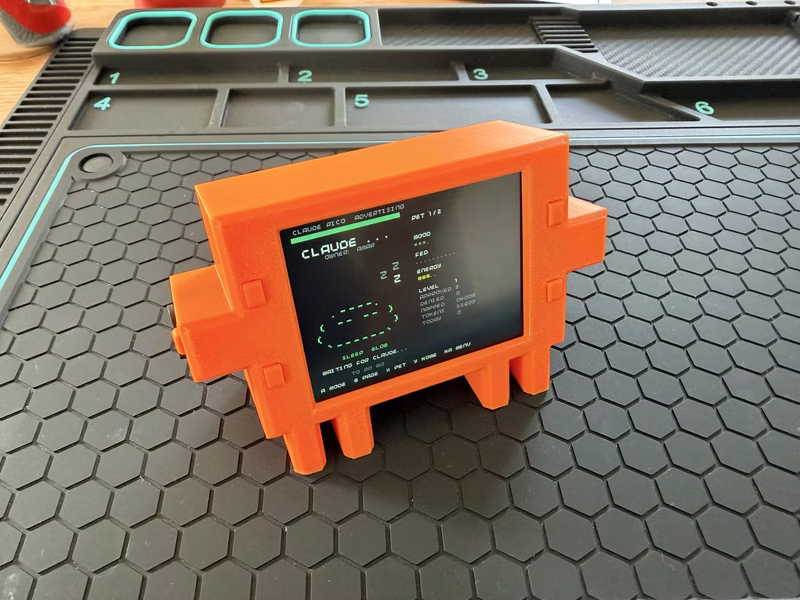 Claude Buddy Pico powered on in the printed case